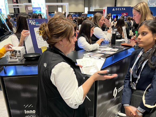 People having discussions at a large scale tradeshow event for careers