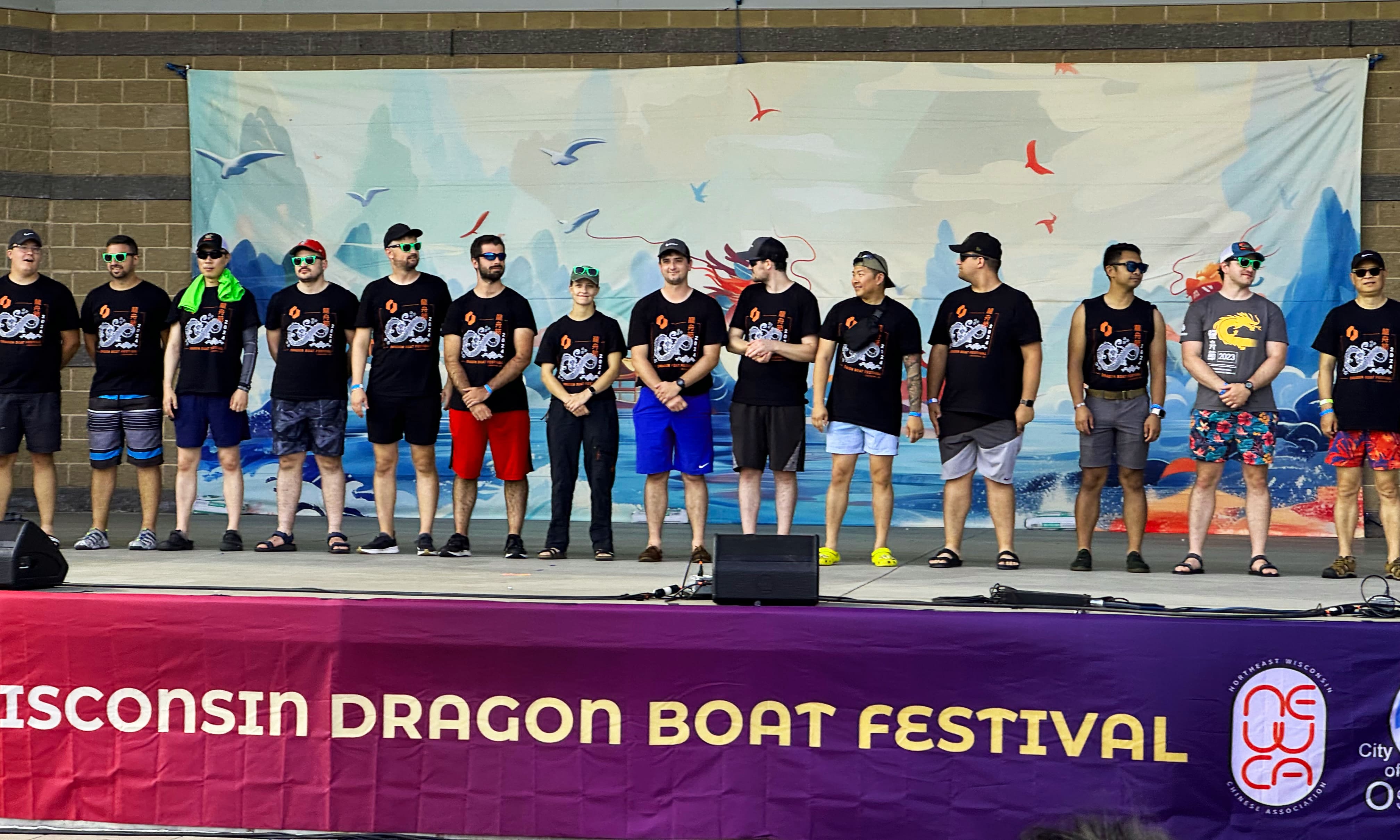Group of people on the stage at the dragon boat festival