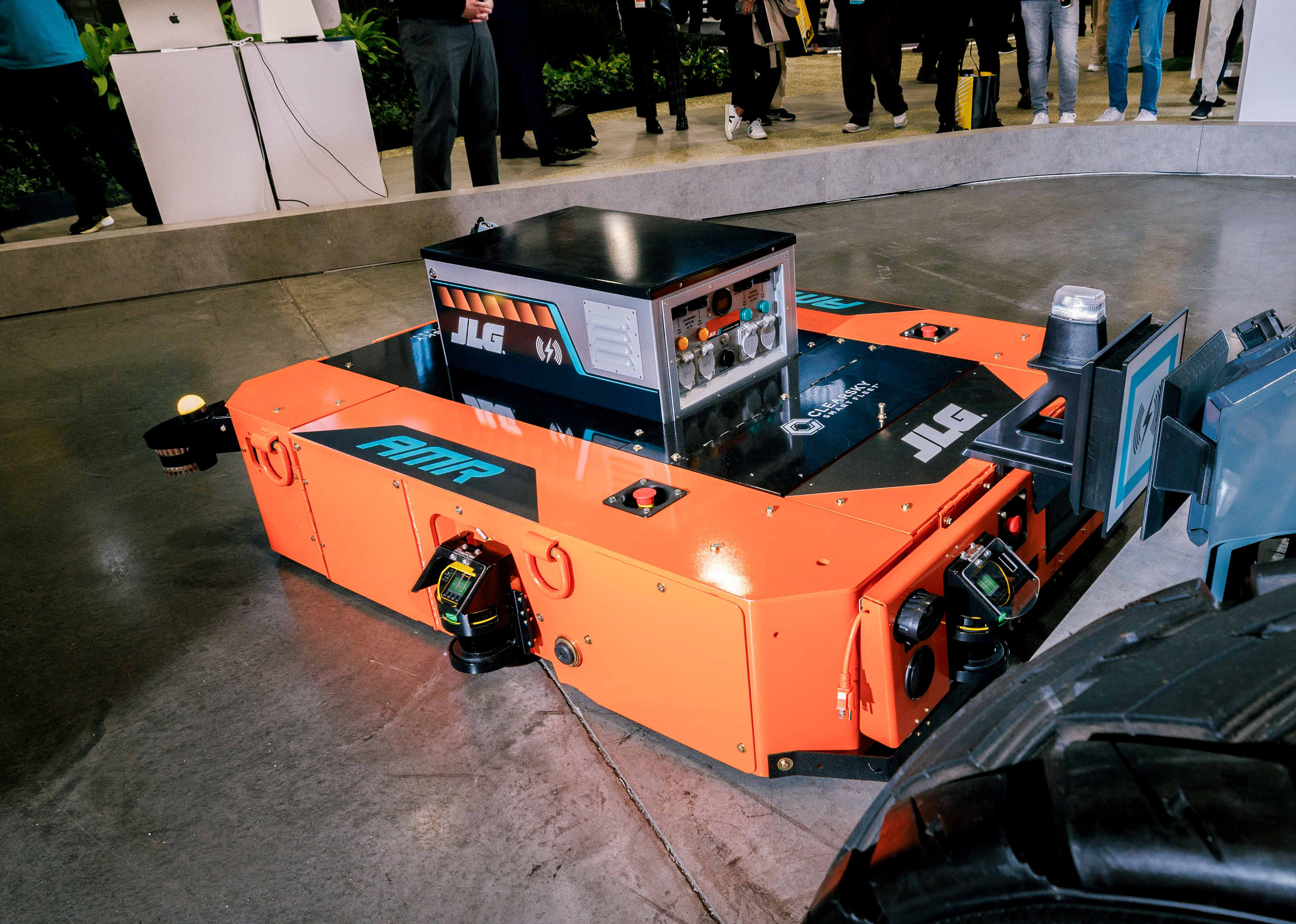 An orange JLG Autonomous Mobile Robot (AMR) featuring advanced logistics and mobility technology on display at CES.