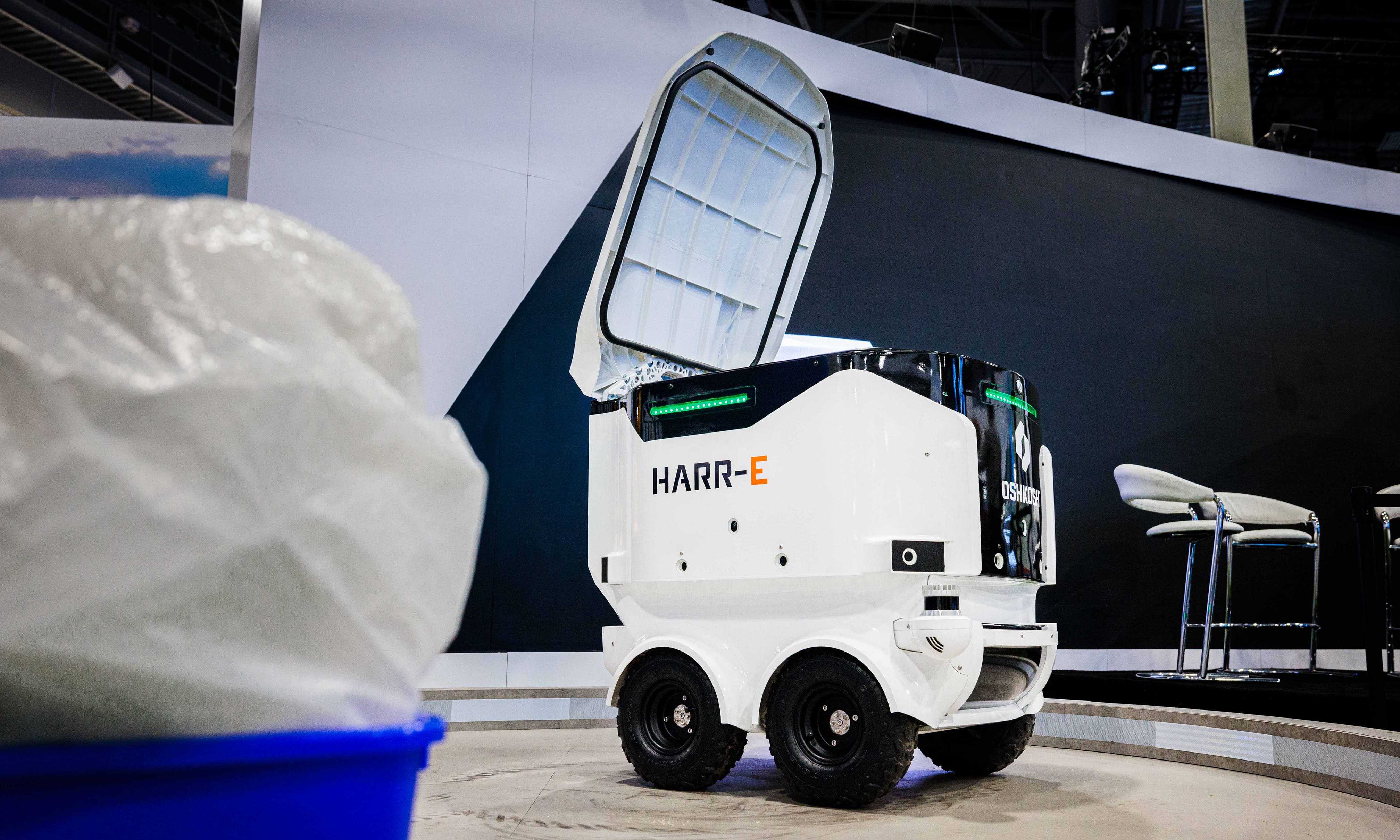 Close-up of the HARR-E autonomous robot at CES, showcasing its design for waste management and material handling.