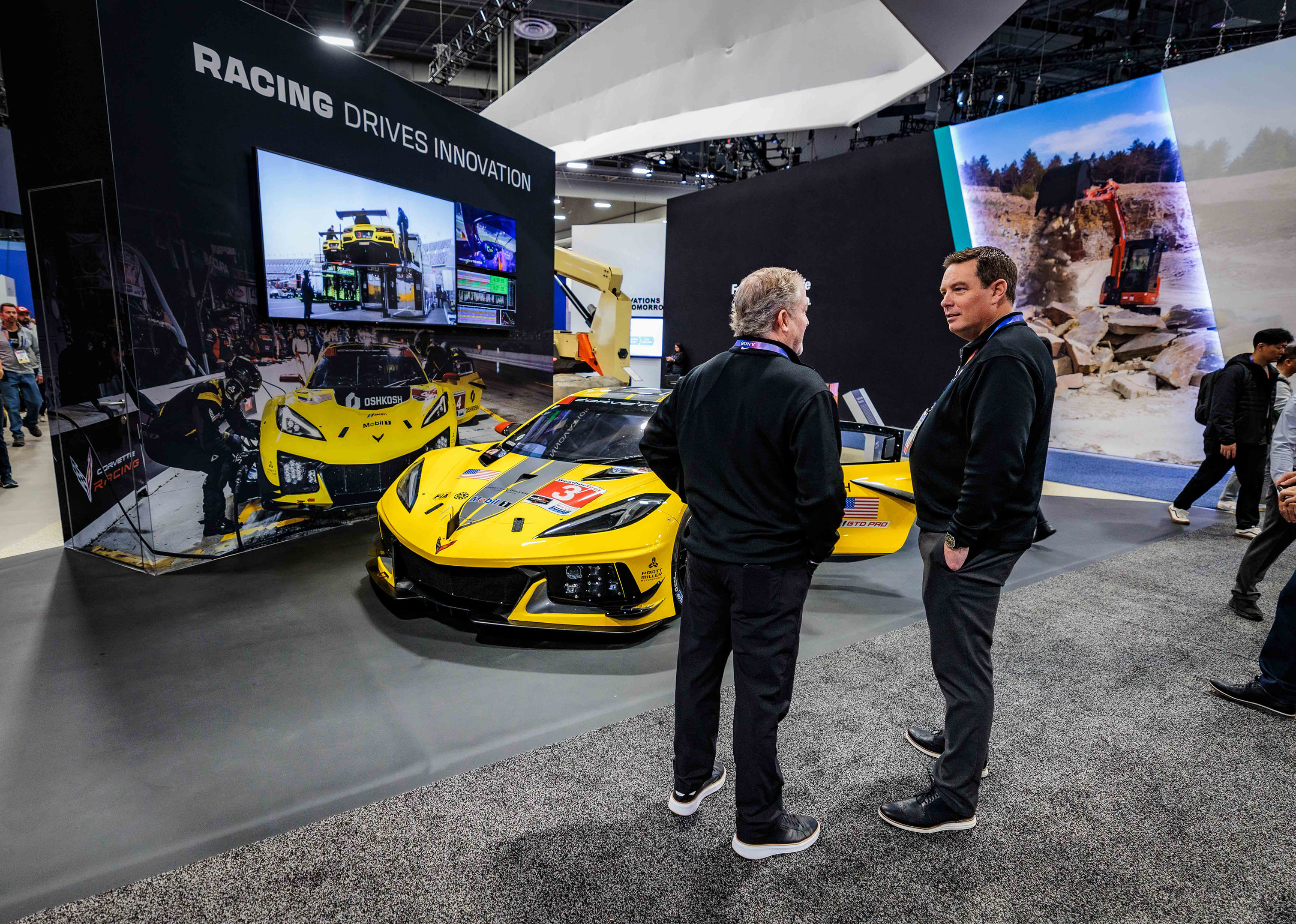 Corvette racing car exhibit at CES, highlighting how Oshkosh integrates racing-inspired innovation into technology.