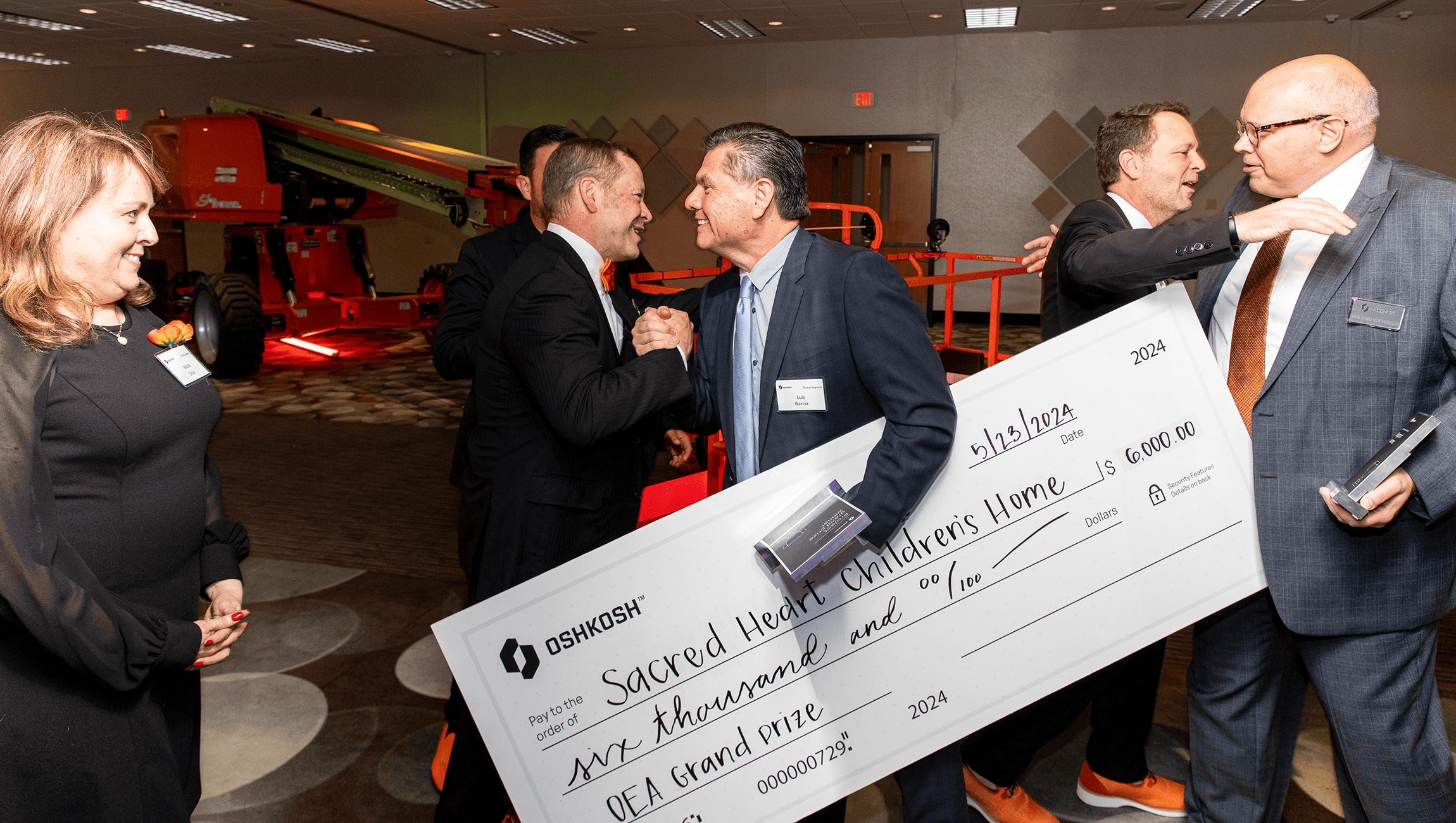 Oshkosh team members accepting an Oshkosh Excellence Awards check for the charity of their choice