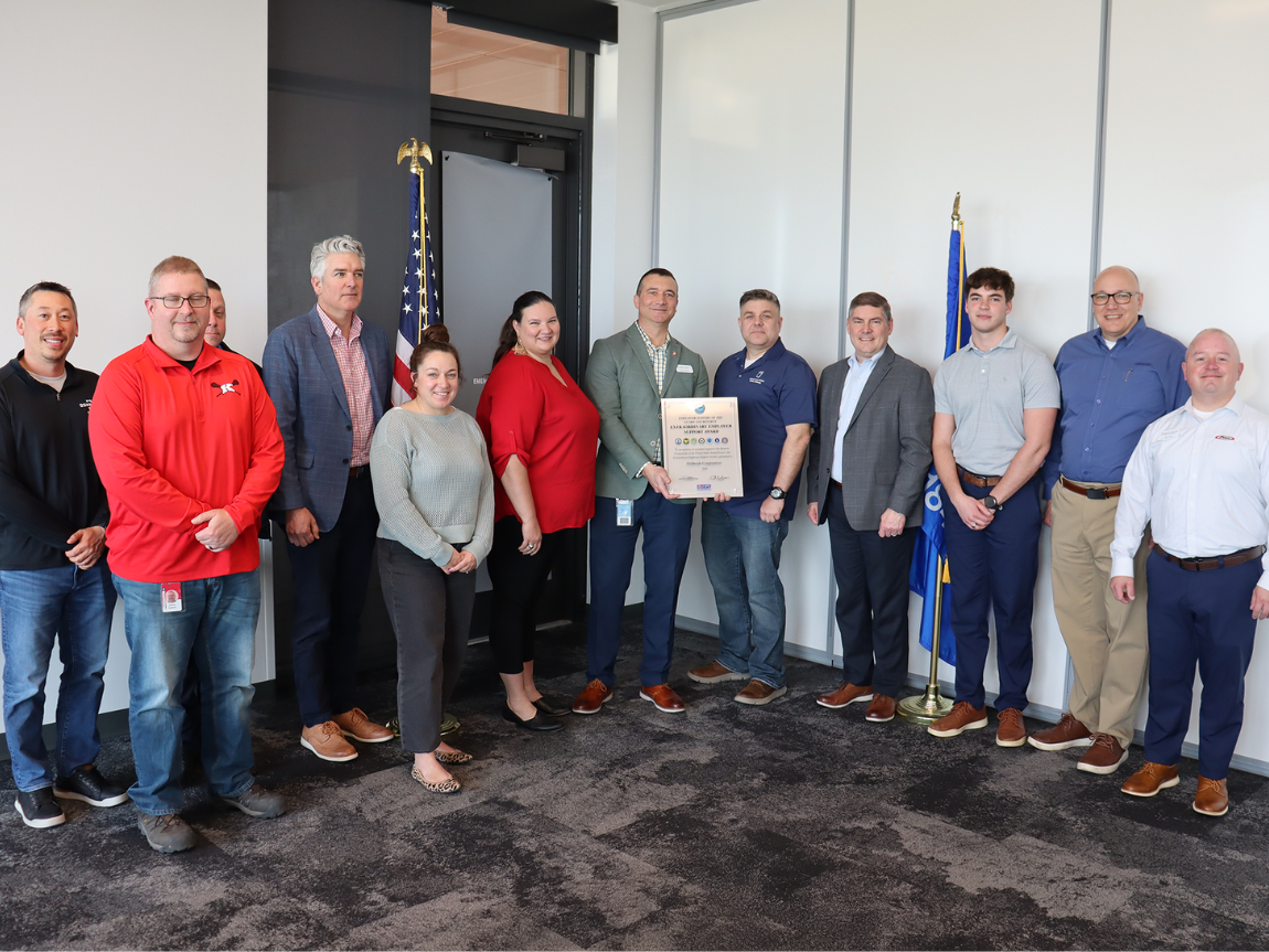 Oshkosh Corporation Military Network team members accepting the award inside the Oshkosh global headquarters