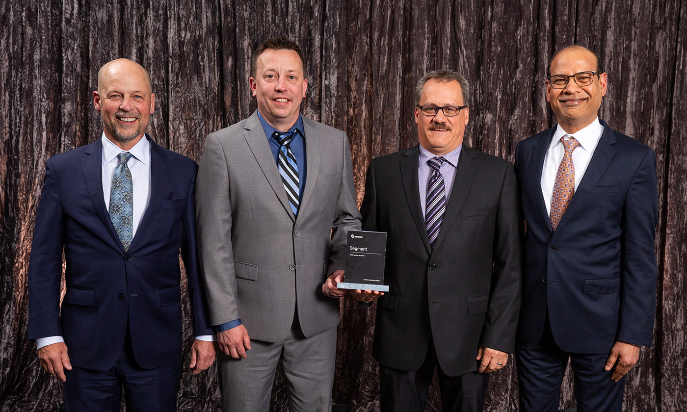 Oshkosh Corporation CEO, John Pfeifer, alongside Anu Khare and Oshkosh team members at the 2025 Oshkosh Excellence Awards
