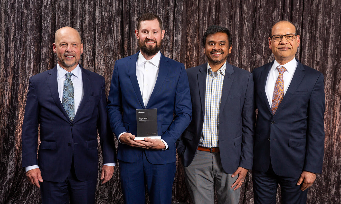 Oshkosh Corporation CEO, John Pfeifer, alongside Anu Khare and Oshkosh team members at the 2025 Oshkosh Excellence Awards