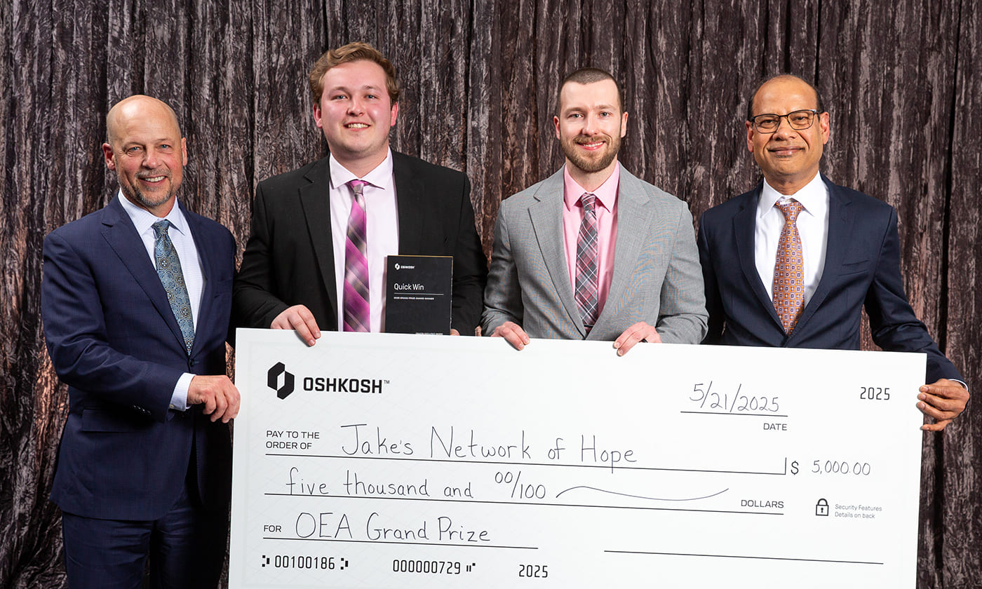 Oshkosh Corporation CEO, John Pfeifer, alongside Anu Khare and Oshkosh team members at the 2025 Oshkosh Excellence Awards