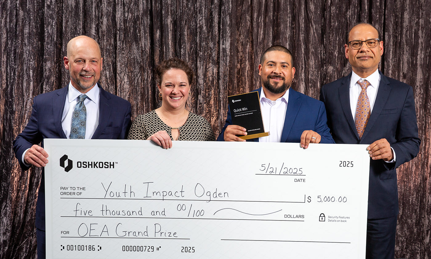 Oshkosh Corporation CEO, John Pfeifer, alongside Anu Khare and Oshkosh team members at the 2025 Oshkosh Excellence Awards