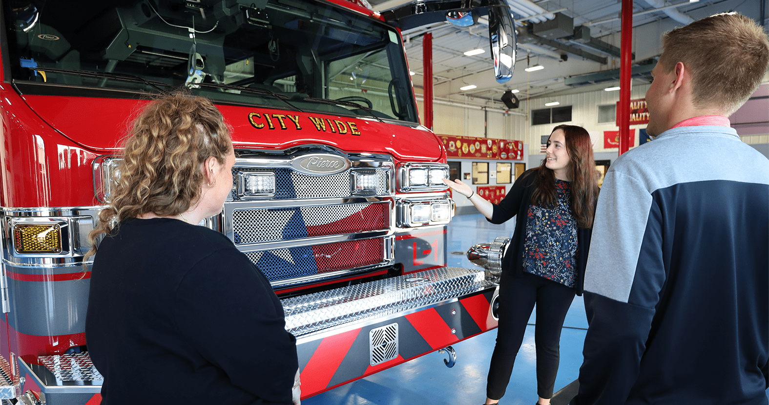  Students pointing at a firetruck. 