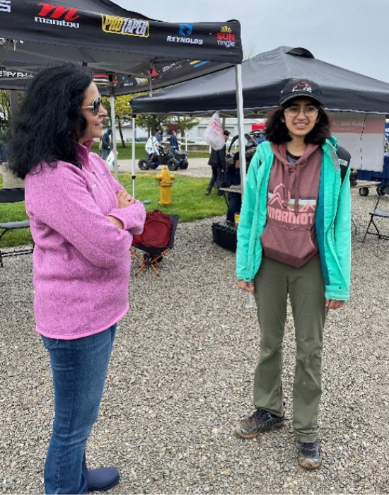Chief technology and strategic sourcing officer, Jay Iyengar, speaking with a Baja event student 