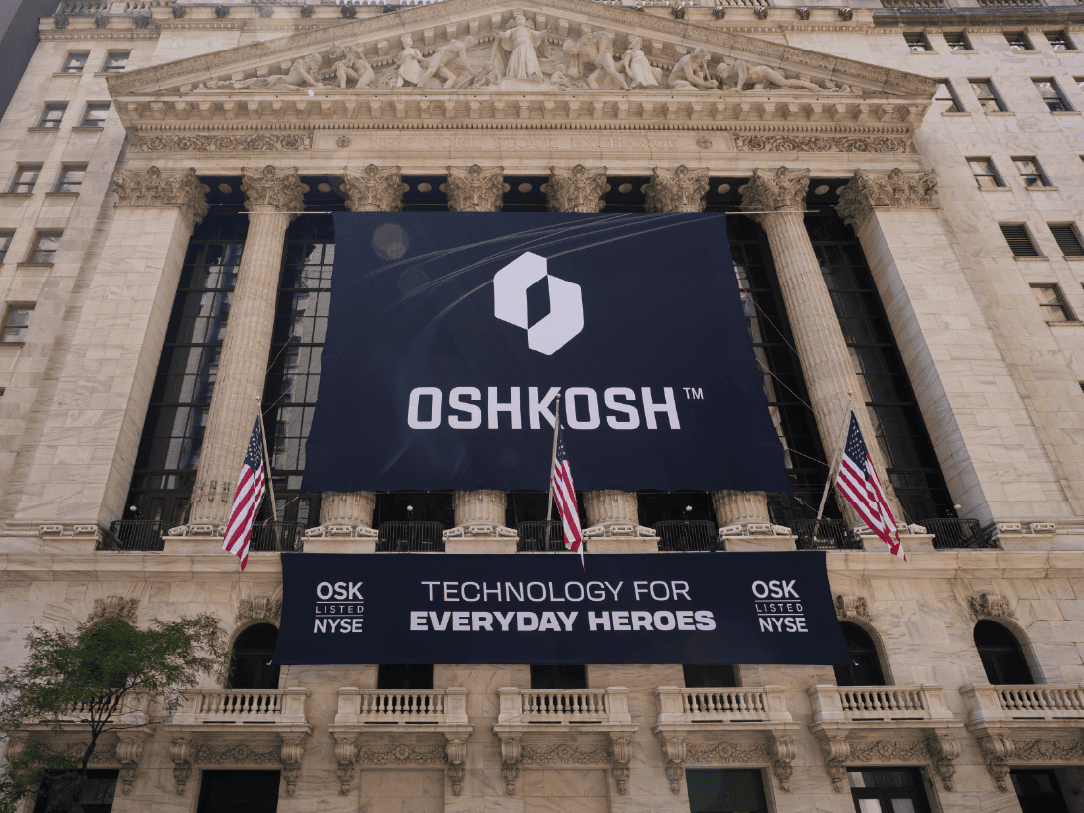 Large black Oshkosh Corporation banners on the New York Stock Exchange building outside