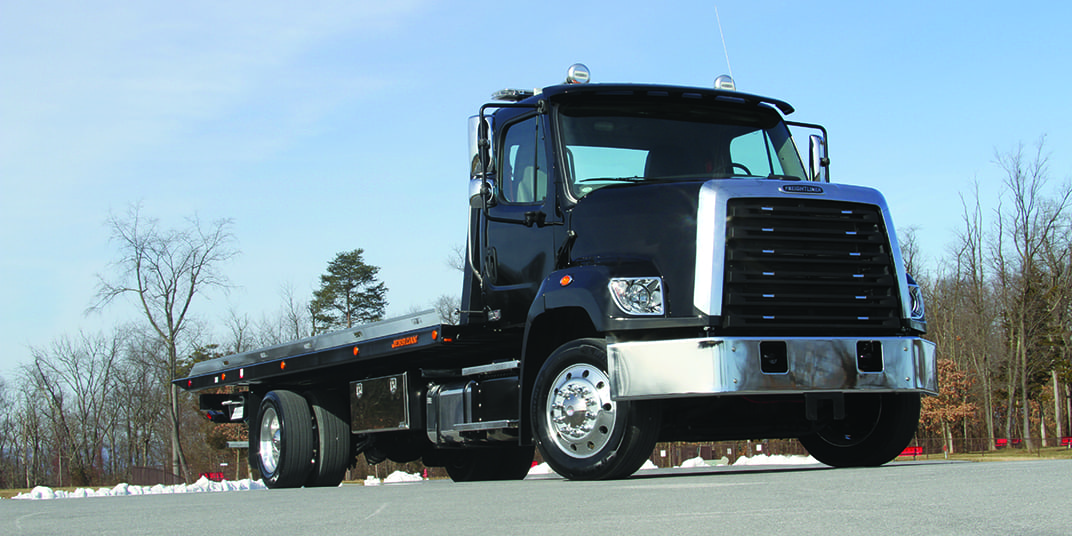 Black Jerr-Dan XLP Carrier parked outside