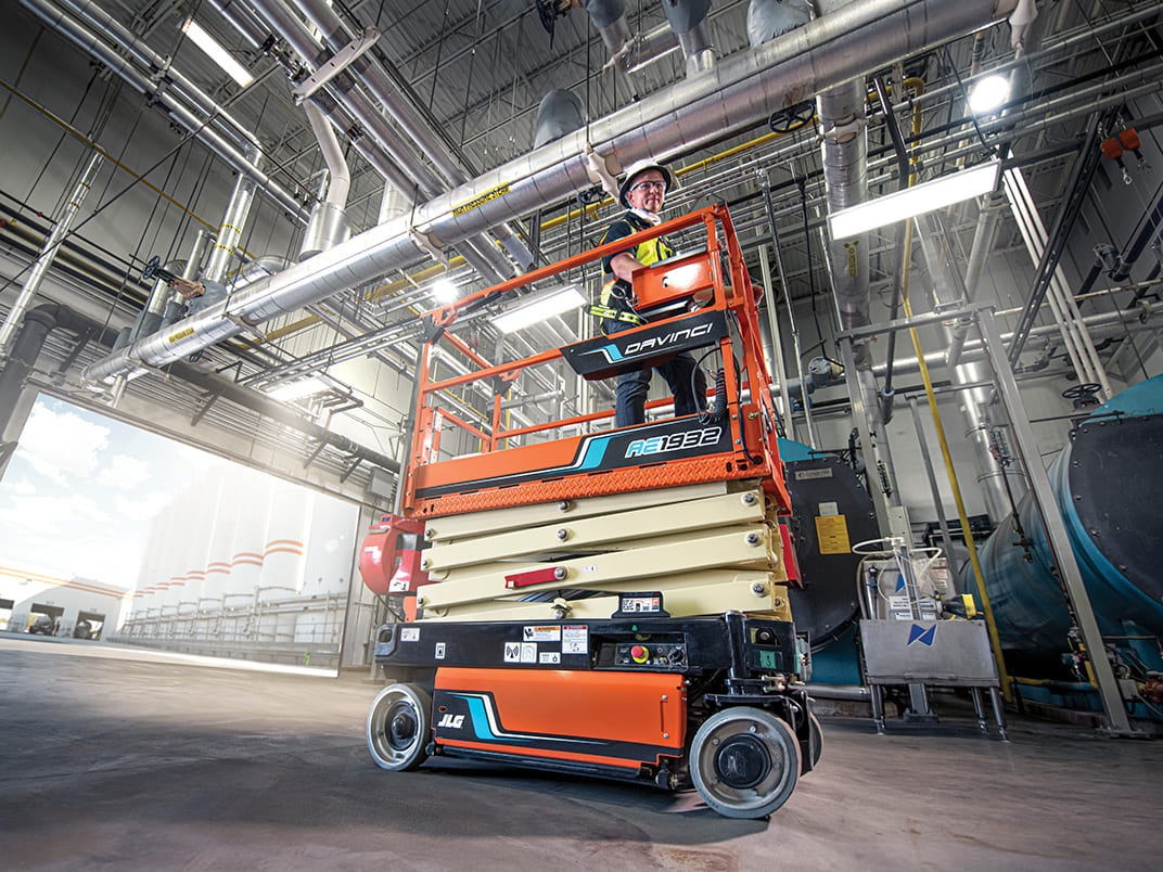 Orange and cream DaVinci all-electric scissor lift operating inside a facility