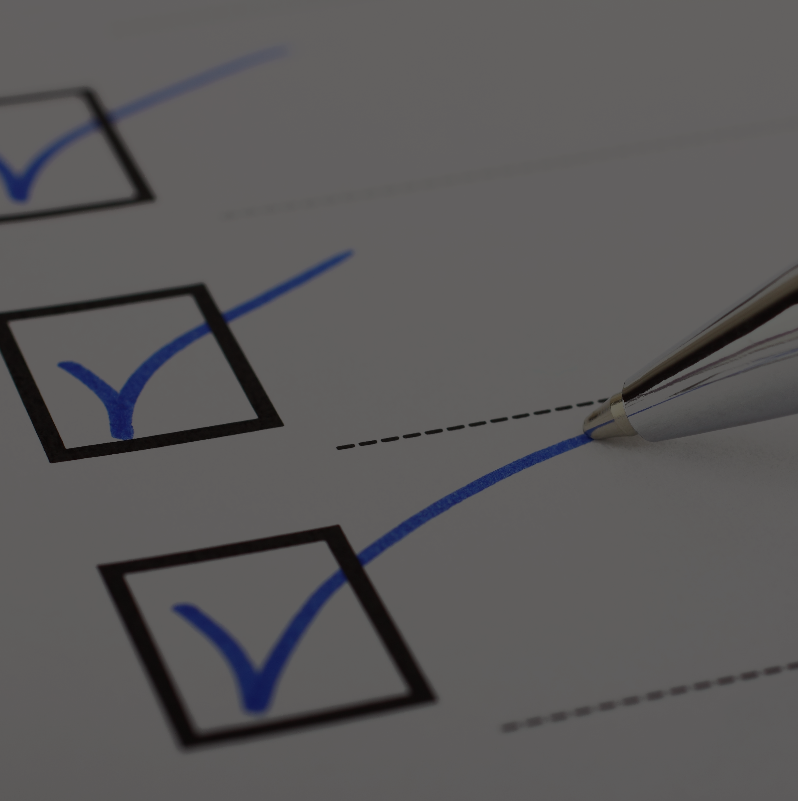 checkboxes with blue checkmarks and a pen on white paper